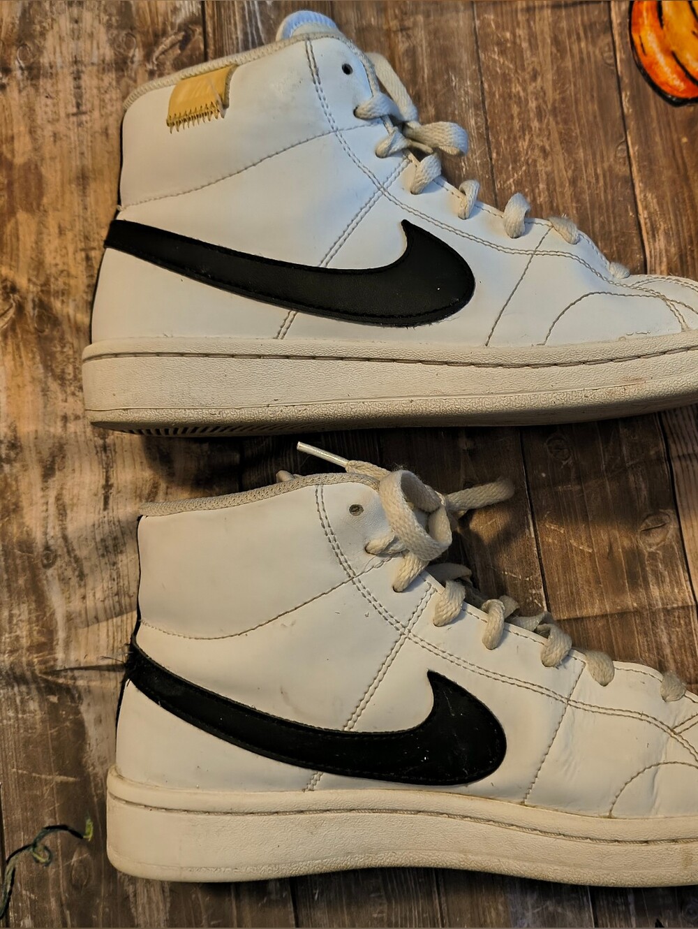 Nike Court Royale Mid sneakers in white/black with the metallic-gold Nike heel